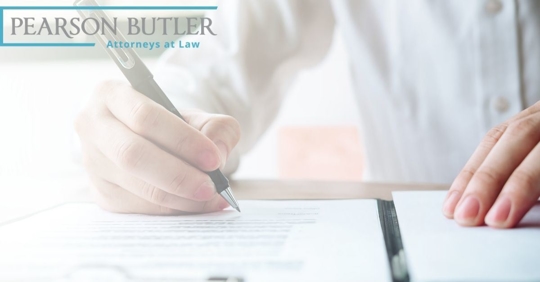 Man using pen to sign a paper